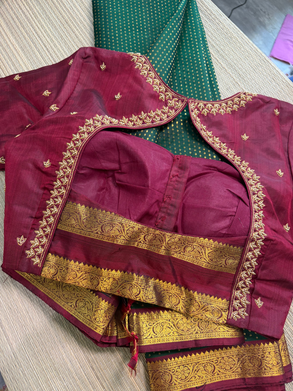 Forest green Kanchipuram saree with gold zari buttas and a rich maroon border