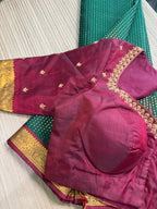Forest green Kanchipuram saree with gold zari buttas and a rich maroon border