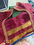 Forest green Kanchipuram saree with gold zari buttas and a rich maroon border