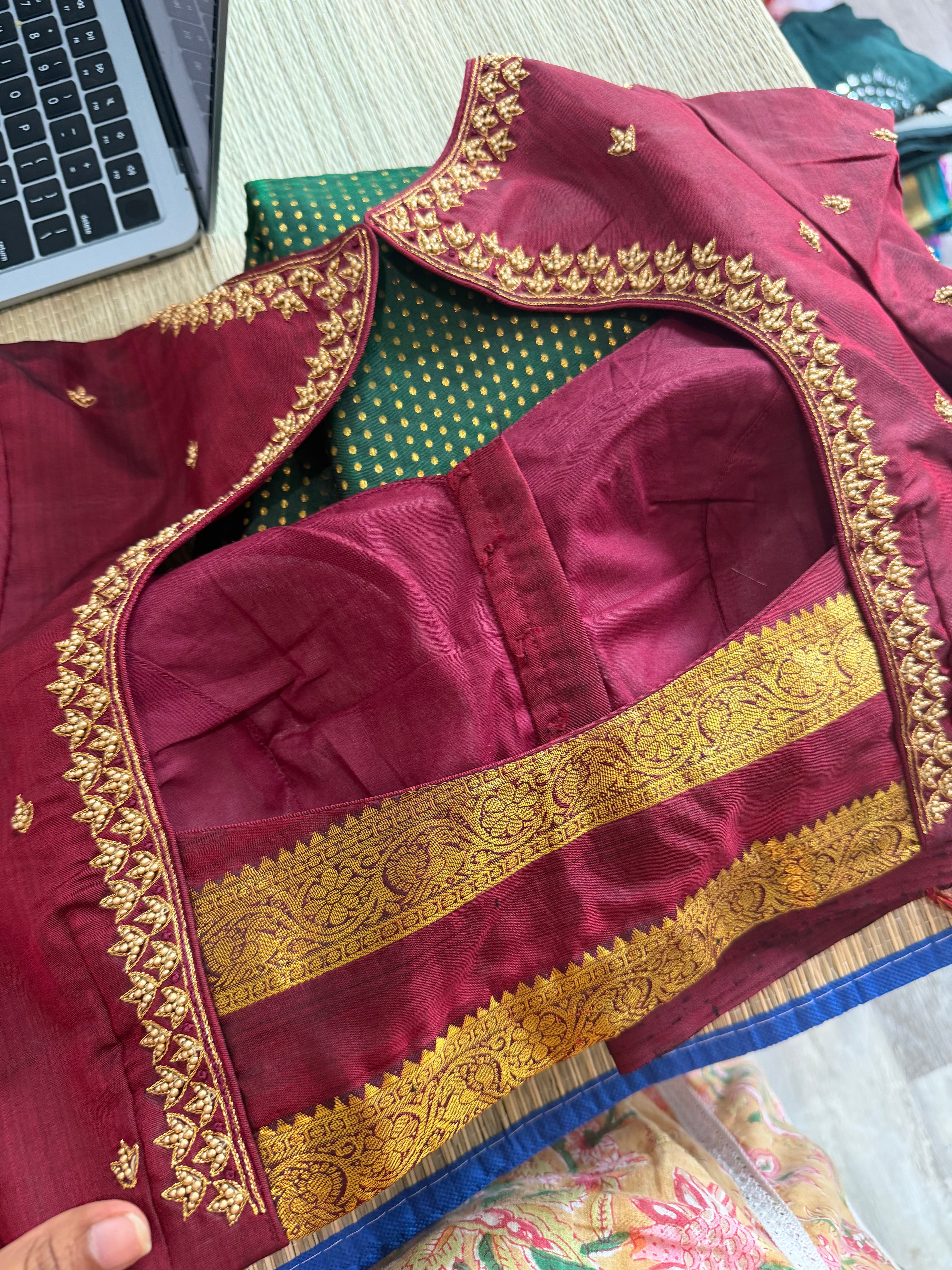 Forest green Kanchipuram saree with gold zari buttas and a rich maroon border